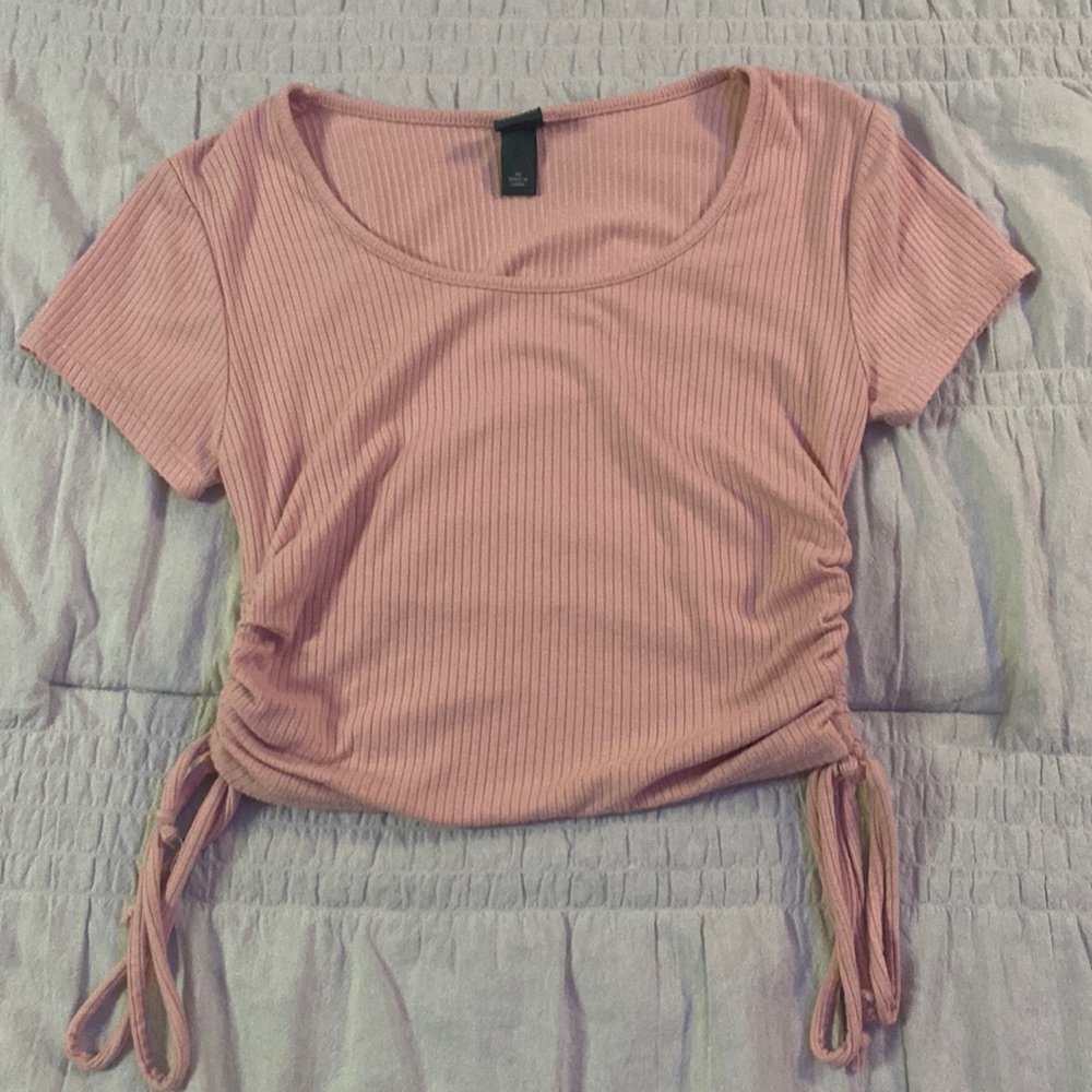 Light pink shirt with strings on the sides